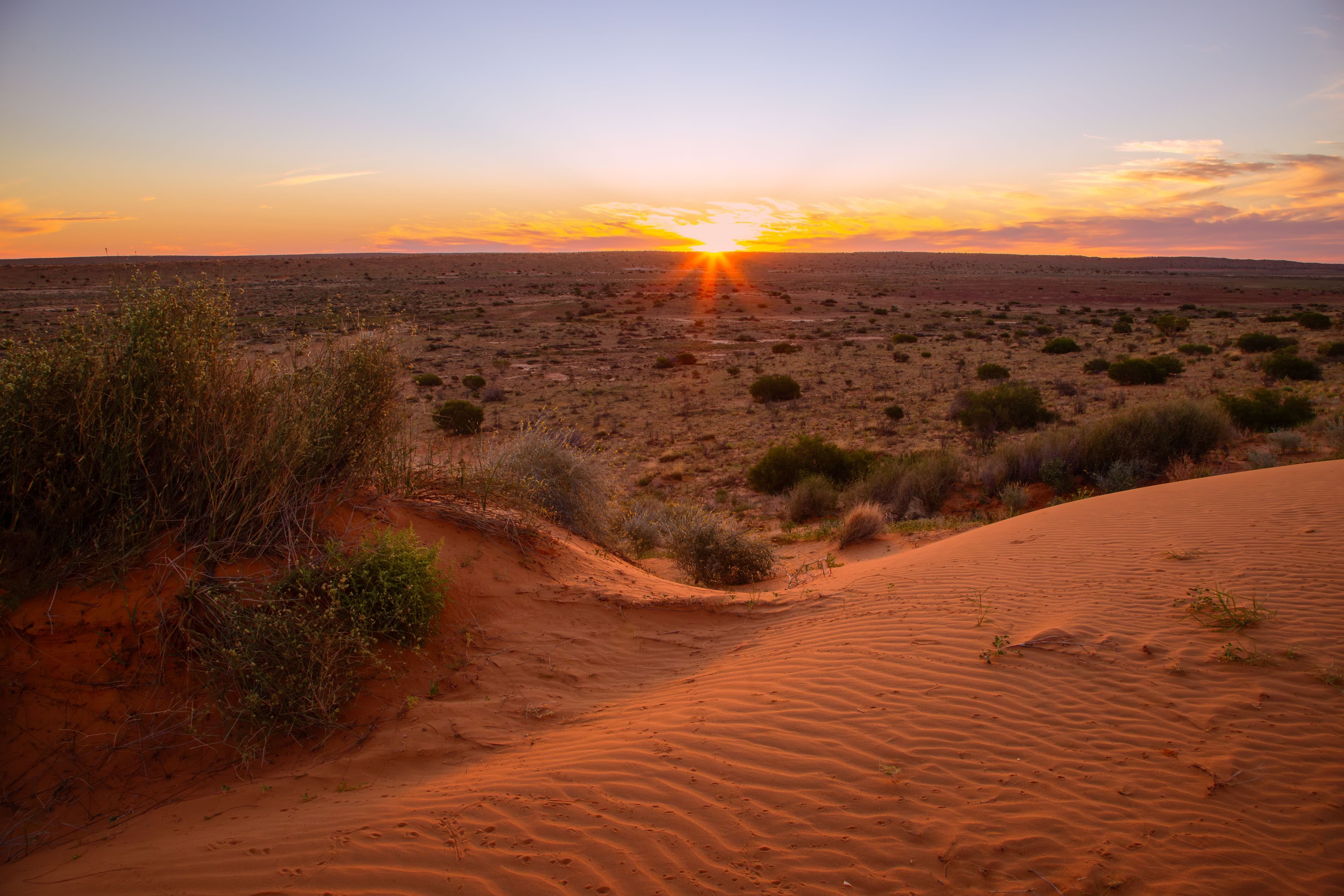free camping in australia with a sunset over the outback