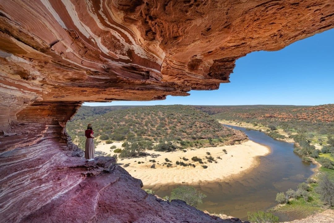 A visitor admires the rock formations and gorges of Kalbarri National Park, Western Australia