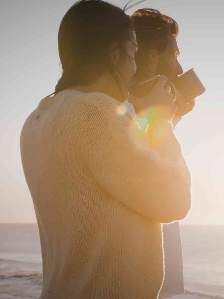 Couple sipping from mugs on a cold day